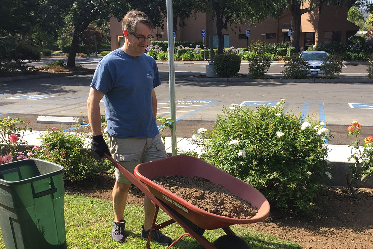 Will works in the neigborhood clearing debris and gardening